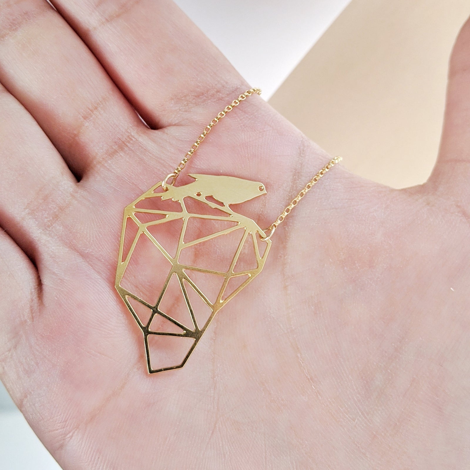 bird on rock necklace